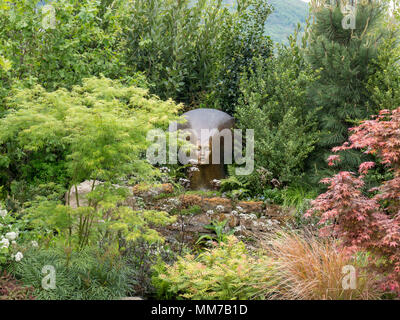 Malvern, Worcestershire, UK. Wednesday 9th May 2018 Malvern, Worcestershire, UK.  Show garden The Spirit of the Woods by Peter Dowle - Gold Medal and Best Construction awards.   Sculptures by Simon Gudgeon. Credit: Ian Thwaites/Alamy Live News Stock Photo