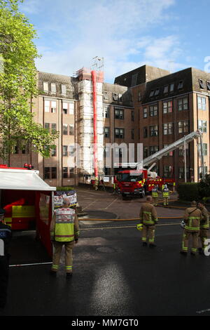 Haywards Heath, Sussex, UK. 10th May 2018. Workers arrive for work and are redirected by the police. Several units from the fire service and police close off Perrymount Road in Haywards Heath, responding to a fire in a large office block. Credit: Roland Ravenhill/Alamy Live News Stock Photo