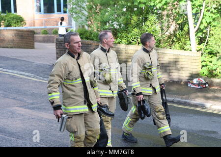 Haywards Heath, Sussex, UK. 10th May 2018. Firemen arrive ready to go to work. Several units from the fire service and police close off Perrymount Road in Haywards Heath, responding to a fire in a large office block. Credit: Roland Ravenhill/Alamy Live News Stock Photo
