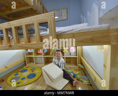 (180510) -- FUZHOU, May 10, 2018 (Xinhua) -- Tao Haiyan's eldest child plays at the new house redesigned by Lan Feng at Xiyangxin Village in Taijiang District of Fuzhou City, capital of southeast China's Fujian Province, May 9, 2018. As an interior designer of Fuzhou City, Lan Feng has paid attention to the living conditions of migrant workers in Fuzhou when she studied at university. More than a month ago, Lan got acquainted with Tao Haiyan from Chongqing, who is about to welcome her second baby, but lives in a narrow and disadvantaged dwelling place rented in Fuzhou with her family. To enhan Stock Photo