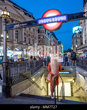Woman Standing Outside Piccadilly Circus Underground Station Lonon UK Stock Photo