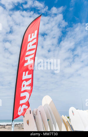 A colourful banner advertising surf hire at Fistral Beach in Newquay Cornwall. Stock Photo
