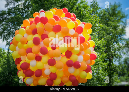 Huge bundle of balloons balloons in golden orange-red colors, party, birthday, celebration,. Festive concept Stock Photo