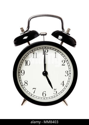 One black alarrm clock displays the time five o clock, isolated on white background. Stock Photo