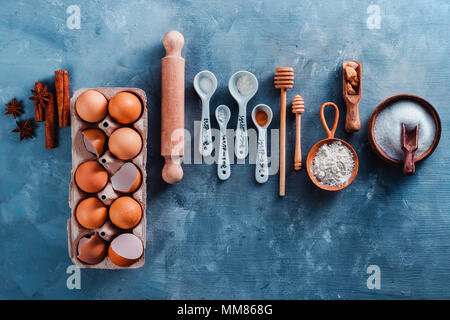 Cooking tools and ingredients from above. Baking concept with measuring  spoons, wooden scoops, whisks, cookie cutters, sugar, flour, eggs and  cinnamon Stock Photo - Alamy