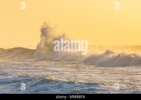 Big stormy waves crashing over Portuguese coast during sunset Stock Photo