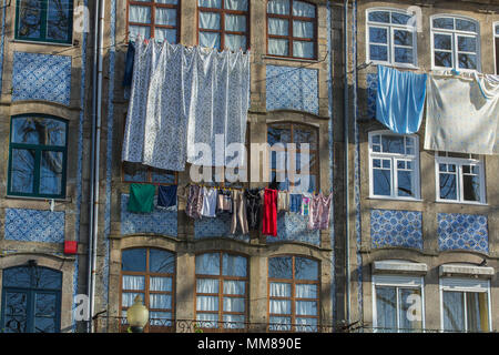 Street view on the beautiful old buildings with portuguese tiles azulejo on the facades in Porto city, Portugal Stock Photo