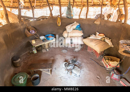 Interior of single-roomed hut with burnt out campfire in the middle, Mukuni Village, Zambia Stock Photo