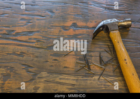 Hammer and nails on wood table Stock Photo