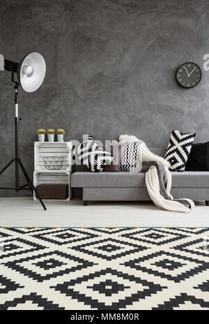 Stylish design of new spacious interior of lounge in big expensive house. Black and white decorations in room Stock Photo