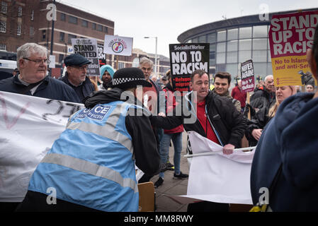 Walsall, West Midlands, UK. 7th April 2018. Pictured:  Police quickly deal with an EDL supporter who infiltrated the anti-fascist demonstration. / Up  Stock Photo
