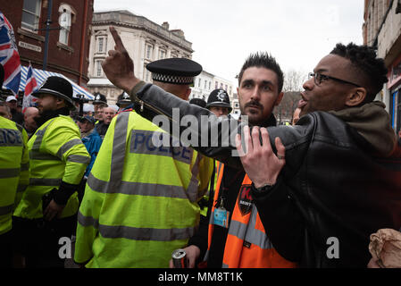 Walsall, West Midlands, UK. 7th April 2018. Pictured:  Locals chant back as EDL supporters march through the town centre. / Up to 60 English Defence L Stock Photo