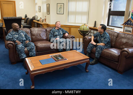 170913-N-MD297-109 YOKOSUKA, Japan (Sept. 13, 2017) Master Chief Petty Officer of the Navy (MCPON) Steven S. Giordano speaks with Capt. Jeffrey Kim, commander, Fleet Activities Yokosuka during an office call in Yokosuka, Japan. Giordano and his wife, Navy Ombudsman-at-Large Elka Franco-Giordano, are on a tour of the U.S. 7th Fleet area of responsibility. (U.S. Navy photo by Mass Communication Specialist 2nd Class Huey D. Younger Jr./Released) Stock Photo