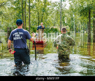 Soldiers from Alpha Battery, 1-265th Air Defence Artillary, perform high water search and rescue with members of the Coast Guard and St. Johns Fire Rescue and firstresponders, in Flagler Estates. Stock Photo