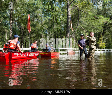 Soldiers from Alpha Battery, 1-265th Air Defence Artillary, perform high water search and rescue with members of the Coast Guard and St. Johns Fire Rescue and firstresponders, in Flagler Estates. Stock Photo