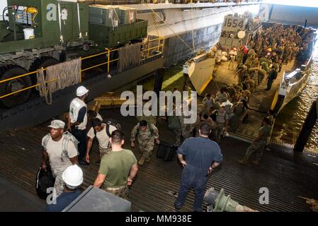 170917-N-WH681-057  CARIBBEAN SEA (Sept. 17, 2017) Service members evacuated from St. Thomas, U.S. Virgin Islands, in anticipation of Hurricane Maria disembark a landing craft utility in the well deck of the amphibious assault ship USS Kearsarge (LHD 3). The Department of Defense is supporting the Federal Emergency Management Agency, the lead federal agency, in helping those affected by Hurricane Irma to minimize suffering and is one component of the overall whole-of-government response effort. (U.S. Navy photo by Mass Communication Specialist 3rd Class Ryre Arciaga/Released) Stock Photo