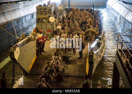170917-N-WH681-053  CARIBBEAN SEA (Sept. 17, 2017) Service members that were evacuated from St. Thomas, U.S. Virgin Islands, in anticipation of Hurricane Maria disembark a landing craft utility in the well deck of the amphibious assault ship USS Kearsarge (LHD 3). The Department of Defense is supporting FEMA, the lead federal agency, in helping those affected by Hurricane Irma to minimize suffering and is one component of the overall whole-of-government response effort. (U.S. Navy photo by Mass Communication Specialist 3rd Class Ryre Arciaga/Released) Stock Photo