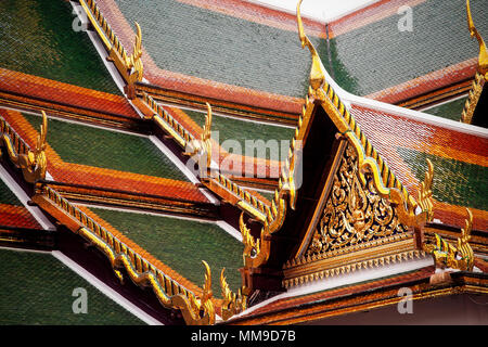 The tiled decorative roof of the Temple of the Emerald Buddha or Uboseth in the Grand Palace complex, Bangkok, Thailand.