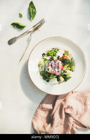 Fresh green summer salad with artichokes, top view Stock Photo