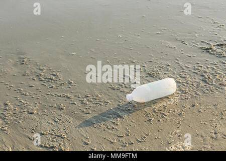 Discarded water bottle laying on a beach. Stock Photo