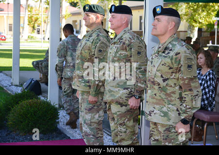 From Left to right, Sgt. Maj. Randy Surles, acting Command Sgt. Maj. U.S. Army Africa, Brig. Gen. Eugene LeBoeuf, acting Command General, USARAF, and Command Sgt. Maj. Jeremiah Inman, USARAF Command Sgt. Maj. stand at attention during an assumption of responsibility ceremony in honor of Command Sgt. Maj. Inman, on Hoekstra Field in Vicenza, Italy, September 20, 2017. Stock Photo