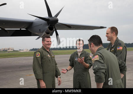 Crewmembers with the 36th Airlift Squadron talks after landing at Yokota Air Base, Japan, Sept. 20, 2017. This is the fifth C-130J delivered to Yokota and the first from Ramstein Air Base. Crewmembers from the 36th Airlift Squadron flew halfway around the world to deliver the aircraft here. Yokota serves as the primary Western Pacific airlift hub for U.S. Air Force peacetime and contingency operations. Missions include tactical airland, airdrop,aeromedical evacuation, special operations and distinguished visitor airlift. (U.S. Air Force photo by Yasuo Osakabe) Stock Photo