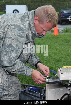 Air National Guard Master Sgt. Bryan Scharman, Joint Incident Site Communication Capability team member with the 151st Air Refueling Wing Communications Flight in Salt Lake City, Utah, sets up a SWE-DISH CCT120 satellite dish outside the Leonard B. Francis Armory in St. Thomas, U.S. Virgin Islands, Sept. 20, 2017. The Sept. 7 deployment of the Utah JISCC helped re-establish critical military and emergency civil service communications within areas of the U.S. Virgin Islands severely impacted by Hurricanes Irma and Maria. (U.S. Air National Guard photo by Master Sgt. Paul Gorman) Stock Photo