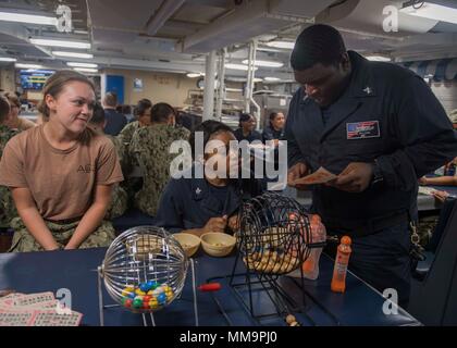 170917-N-TJ319-010 CARIBBEAN SEA (Sept. 17, 2017) Sailors check a winning bingo card during a Morale, Welfare and Recreation (MWR) event aboard the dock landing ship USS Oak Hill (LSD 51). The Department of Defense is supporting Federal Emergency Management Agency, the lead federal agency, in helping those affected by Hurricane Maria to minimize suffering and is one component of the overall whole-of-government response effort. (U.S. Navy photo by Mass Communication Specialist Seaman Jessica L. Dowell) Stock Photo