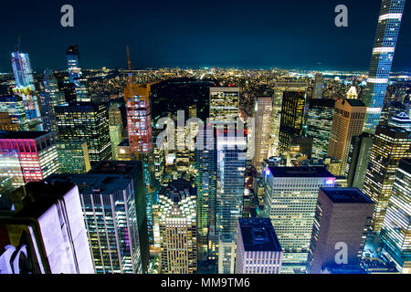 Aerial view of Manhattan skyline illuminated at night. New York, USA.