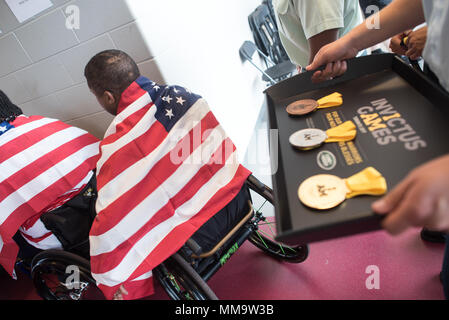 Several Team U.S. athletes prepare to recieve medals during the Athletics competition of the 2017 Invictus Games at the York Lions Stadium in Toronto, Canada, Sept. 24, 2017. More than 550 wounded, ill and injured servicemen and women from 17 allied nations are expected to compete. (DoD Photo by U.S. Army Sgt. James K. McCann) Stock Photo