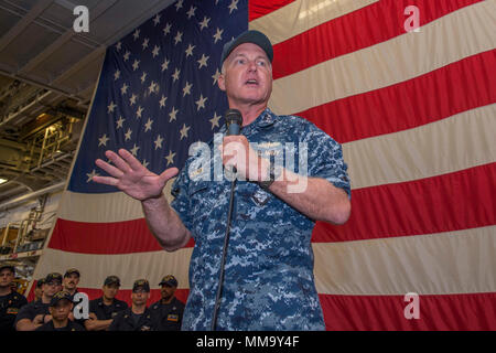 170925-N-DC385-506 SASEBO, Japan (Sept. 25, 2017) Vice Adm. Tom Rowden, commander, Naval Surface Forces, addresses Sailors during an all-hands call in the ship’s hangar bay of the amphibious assault ship USS Bonhomme Richard (LHD 6). Rowden is visiting Fleet Activities Sasebo, home of the 7th Fleet’s forward-deployed amphibious ships, to better understand forward-deployed readiness challenges and to discuss the role of the new command Naval Surface Group Western Pacific organization. (U.S. Navy photo by Mass Communication Specialist Seaman Cosmo Walrath/Released) Stock Photo