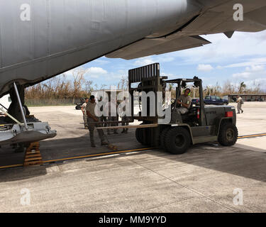 Tech. Sgt. Efrain Rodriguez, 156th Airlift Wing, unloads a pallet of supplies at Muniz Air National Guard Base, Puerto Rico, Sept. 24, 2017. The Puerto Rico Air National Guard is working with numerous local and federal agencies in response to Hurricane Maria. (U.S. Air National Guard photo by Tech. Sgt. Dan Heaton) Stock Photo