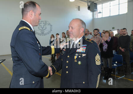 Oregon Army National Guard Brig. Gen. William Edwards, Land Component Commander, shakes hands with Command. Sgt. Maj. Brunk W. Conley after awarding him the Oregon National Guard Commendation Medal during a retirement ceremony on September 22, 2017, at the Corvallis Armory. Conley said that the medal meant a lot because it showed his dedication to his home state. (Photo by Spc. Timothy Jackson, 115th Mobile Public Affairs Detachment) Stock Photo