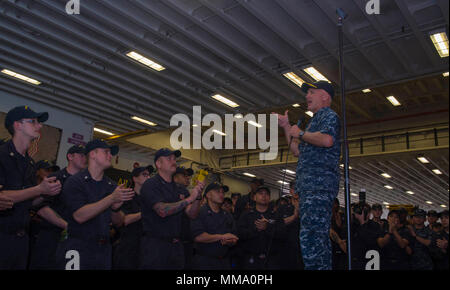 170925-N-RD713-432 SASEBO, Japan (Sept. 25, 2017) Vice Adm. Tom Rowden, commander of Naval Surface Forces, U. S. Pacific Fleet, addresses Sailors during an all-hands call in the hangar bay of the amphibious assault ship USS Bonhomme Richard (LHD 6). Rowden is visiting Fleet Activities Sasebo, home of the 7th Fleet’s forward-deployed amphibious ships, to better understand forward-deployed readiness challenges and to discuss the new command Naval Surface Group Western Pacific. (U.S. Navy photo by Mass Communications Specialist 3rd Class Zachary DiPadova/Released) Stock Photo