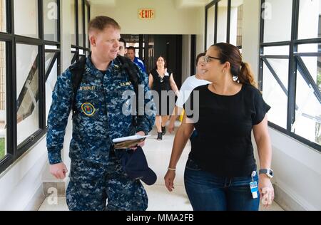 170926-N-IM651-004  UTUADO, Puerto Rico (Sept. 26, 2017) Yelitza Sanchez Rodriguez, right, director of operations at the Metropolitano De La Montana Hospital, and Lt. Alan Gutberlet, assigned to Fleet Surgical Team 4, discuss hospital operations during hospital assessments in Utuado, Puerto Rico. The Department of Defense is supporting the Federal Emergency Management Agency, the lead federal agency, in helping those affected by Hurricane Maria to minimize suffering and as one component of the overall whole-of-government response efforts.  (U.S. Navy photo by Gunners Mate 1st Class Jonathan Ed Stock Photo