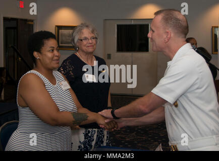 WASHINGTON (Sept. 24 2017) Master Chief Petty Officer of the Navy, Steven Giordano, shakes hands with a Gold Star family member at the Gold Star Mother's and Family Day observance at Joint Base Anacostia-Bolling. MCPON served as a guest speaker during the event, which honored and recognized the sacrifices of Gold Star families. (U.S. Navy photo by Mass Communication Specialist 2nd Class Jason Amadi/RELEASED) Stock Photo
