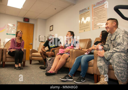 Valerie Miller (left), nurse midwife, Department of Women’s Health Services, William Beaumont Army Medical Center, conducts a group prenatal care session with parents of newborns to discuss concerns, expectations and answer any questions the couples may have regarding their birthing experience at WBAMC, Sept. 28. National Midwifery Week is celebrated Oct. 1-7 and recognizes midwives and their roles in women’s health. William Beaumont Army Medical Center is the only hospital in El Paso, Texas to provide 24/7 midwifery services for mothers in labor. Stock Photo