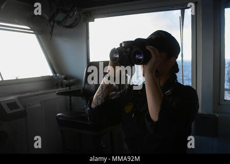 170928-N-FA466-013 HONG KONG HARBOR (Oct. 6, 2017) – Master-at-Arms 2nd Class Alexis Kettelhut, from Barnum, Minnesota, trains as Antiterrorism Tactical Watch Officer (ATTWO) on the navigation bridge of the Navy's forward-deployed aircraft carrier, USS Ronald Reagan (CVN 76), as the ship steams along the coast of China after a scheduled port visit in Hong Kong. During the port visit, Sailors participated in 10 community relations events, seven Morale, Welfare and Recreation tours, and several sporting events with the host nation. Ronald Reagan, the flagship of Carrier Strike Group 5, provides  Stock Photo