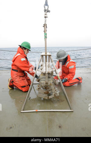 USCGC Healy (WAGB-20) supports Arctic scientific missions including sediment sampling using a HAPS bottom corer. The archival image records science team members removing core samples during research operations in Arctic waters on 5 September 2017. Stock Photo