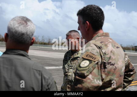 Donald J. Trump, president of the United State of America, visited Puerto Rico after the path of Hurricane Maria in the island, Oct. 3, Carolina, Puerto Rico. The adjutant general of P.R., Brig. Gen. Isabelo Rivera, along with Lt. Gen. Jeffrey Buchanan, US Army North Commanding General, and the governor of P.R., Ricardo Rosselló, welcomed the president on his arrival to the island. (Photo by Sgt. José Ahiram Díaz/PRNG-PAO/Released) Stock Photo