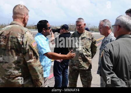 Donald J. Trump, president of the United State of America, visited Puerto Rico after the path of Hurricane Maria in the island, Oct. 3, Carolina, Puerto Rico. The adjutant general of P.R., Brig. Gen. Isabelo Rivera, along with Lt. Gen. Jeffrey Buchanan, US Army North Commanding General, and the governor of P.R., Ricardo Rosselló, welcomed the president on his arrival to the island. (Photo by Sgt. José Ahiram Díaz/PRNG-PAO/Released) Stock Photo