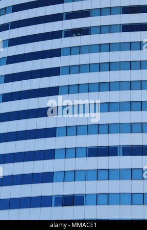 White architectural structure with blue sky background with blue windows Stock Photo