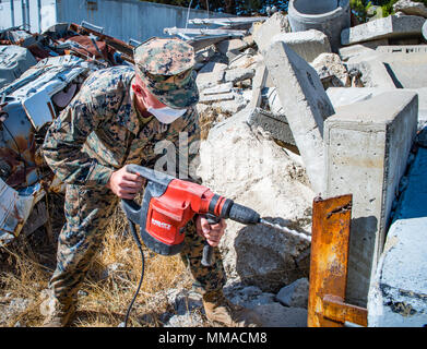 SAN FRANCISCO (Oct. 3, 2017) Pfc. Tanner Thawley, attached to Combat Logistics Battalion 11, uses a hammer drill for urban search and rescue training during Fleet Week San Francisco 2017. Fleet week provides an opportunity for the American public to meet their Navy, Marine Corps, and Coast Guard team and to experience America’s sea service. Fleet Week San Francisco will highlight naval personnel, equipment, technology, and capabilities, with an emphasis on humanitarian assistance and disaster response.  (U.S. Navy Photo by Mass Communication Specialist 2nd Class Eric Chan) Stock Photo