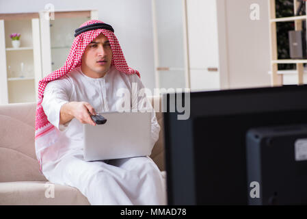 Arab businessman watching tv at home Stock Photo