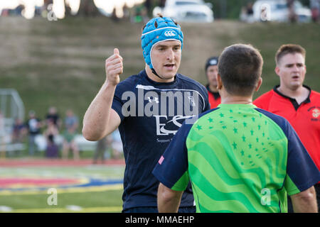 A Royal Sailor assigned to the Royal Navy Rugby Team speaks to a referee during an exhibition game between the All Marine Rugby Team and Royal Navy Rugby Team at Butler Stadium on Marine Corps Base Quantico, Va., Sept. 20, 2017. The match was a part of the Royal Navy Rugby Union Senior XV Tour, which consisted of matches against the United States Naval Academy and the Potomac Rugby Club. (U.S. Marine Corps photo by Lance Cpl. Cristian L. Ricardo) Stock Photo