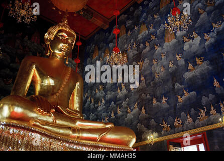 The Buddha and a fresco of angels in the ubosot of the Buddhist temple Wat Thewa Ratchakunchon in Bangkok in Thailand in Southeast Asia Far East. Stock Photo