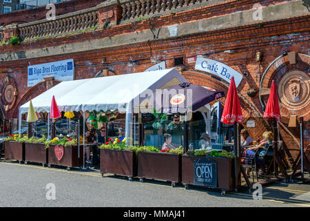 People enjoying a drink on a sunny day in a ramsgate harbour quayside restaurant. Stock Photo