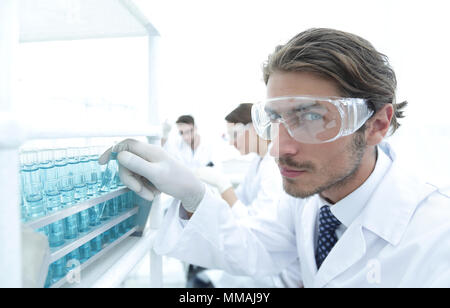 man in goggles to check fluid in vitro. Stock Photo