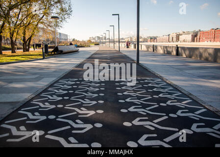 Pedestrian crossing sign on asphalt in city public park. The walking man. Permission to walk pedestrians. Stock Photo