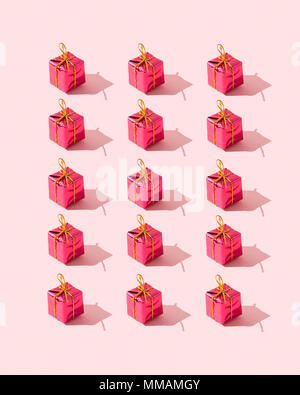 Small gift boxes organized over pink background Stock Photo